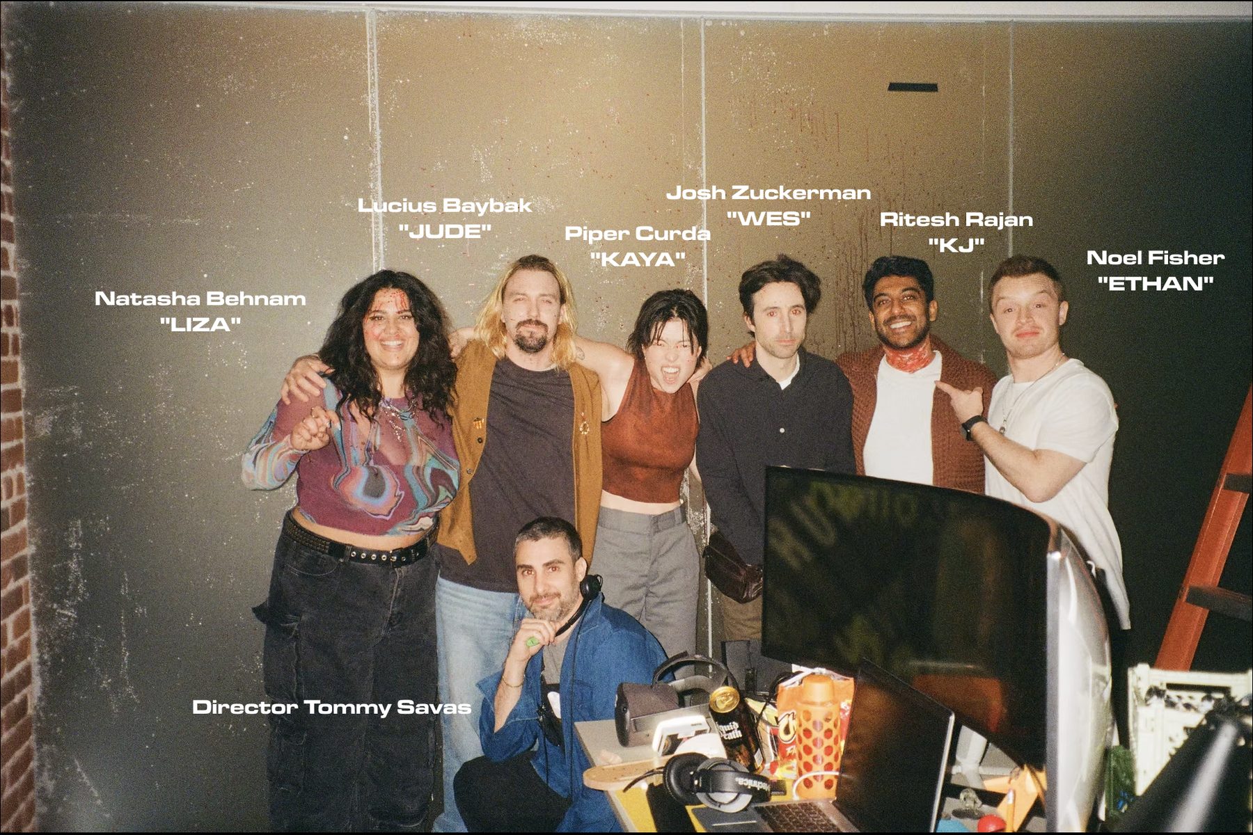 Cast and crew of COG on set, with names and character labels overlaid